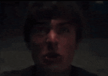 a close up of a man 's face with his mouth wide open
