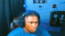 a man wearing headphones is sitting in a chair in a room .