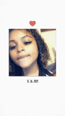 a picture of a girl with curly hair and the date 11.16 2019