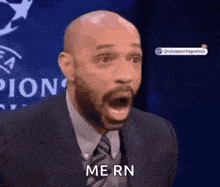 a man in a suit and tie is making a surprised face and saying me rn .