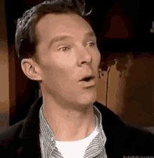 a close up of a man making a surprised face .