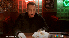 a man sitting at a bar with the hashtag #chicagopd on the bottom right