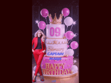 a woman in a red suit stands in front of a birthday cake that says happy birthday