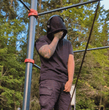 a man wearing headphones covering his face while standing on a bar