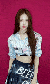a woman wearing a crop top and a skirt that says beep on it