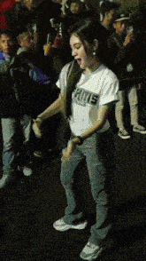 a girl wearing a shirt that says ' rams ' on it is dancing