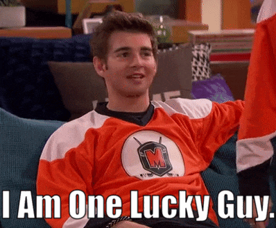 a man sitting on a couch wearing a jersey that says 