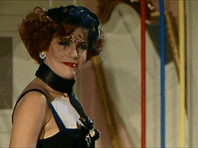 a woman with red hair wearing a black choker