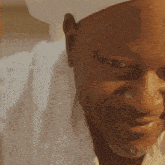 a close up of a man wearing a chef 's hat and white shirt