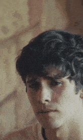 a close up of a young man 's face with a serious look on his face