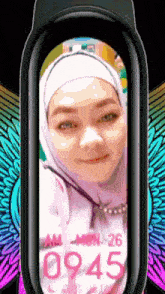a woman wearing a hijab is displayed on a smart watch with the time of 09:45
