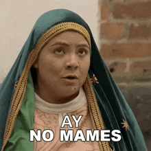 a woman in a virgin mary costume is making a funny face and saying ay no mames .