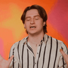 a man wearing a striped shirt and a necklace with a cross on it