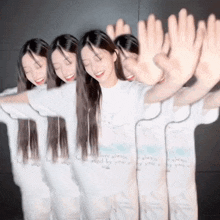 a woman wearing a white shirt that says " there always is an angel by your side " holds her hands up