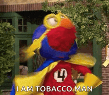 elmo from sesame street is wearing a cape with the number 4 on it