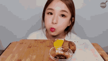 a woman sitting at a table with a plate of food and a hamzy logo