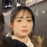 a close up of a woman 's face with a blurry background .