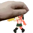 a hand is holding a cartoon character with a yellow object in its mouth .