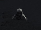 a black and white photo of a woman laying on the ground