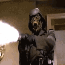 a man in a mask is holding a gun in his hand