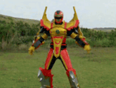 a red and yellow robot standing in a grassy field
