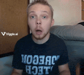 a man wearing a t-shirt that says " woojack hoot " looks surprised