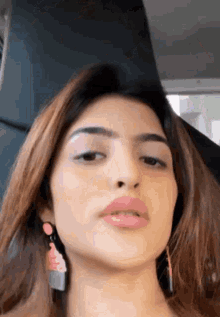 a close up of a woman 's face in a car .