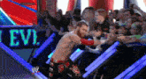 a man in a wrestling ring with a sign that says ' levi ' on it