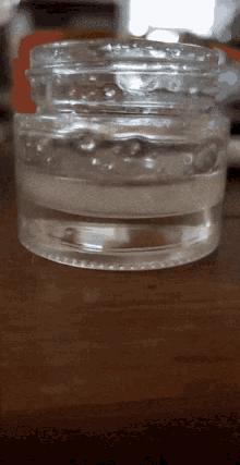 a clear plastic jar with a white liquid inside