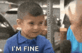 a young boy in a blue shirt says " i 'm fine "