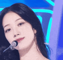 a close up of a woman holding a microphone to her mouth