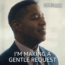 a man in a suit and tie is smiling and saying i 'm making a gentle request