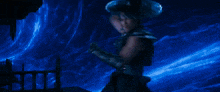 a group of people are fighting each other in a dark room with lights coming out of the ceiling .