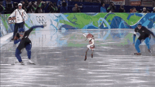 a group of people are ice skating in front of a sign that says brooklyn on it