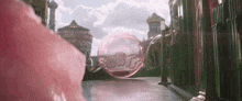 a large bubble is floating in the air in front of a castle