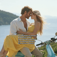 a man is holding a woman in his arms while sitting on a motorcycle
