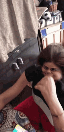 a woman is making a funny face while being punched in the face