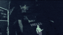 a man wearing a black shirt that says hello
