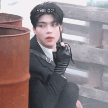 a man in a suit is holding a walkie talkie in his hand