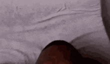 a close up of a person laying on a bed .