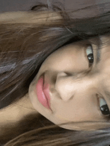 a close up of a woman 's face with a necklace around her neck