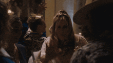 a group of people are gathered in a dark room