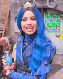 a woman with blue hair and a crown on her head is holding a bottle of water and smiling .