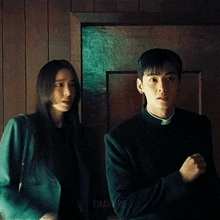 a man and a woman are standing next to each other and the man is wearing a priest 's robe