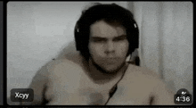 a shirtless man wearing headphones is on a video call with xcyy at 4:36