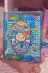 a person is holding a toy that says usa hana on the front