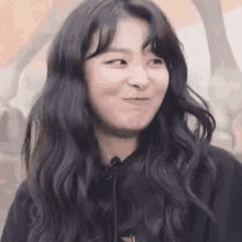 a close up of a woman making a funny face with her mouth open .