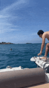 a man standing on a boat with the number hida on it