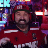 a man with a beard wearing headphones and a marvel jersey