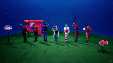 a group of young men are dancing and one of them is wearing a shirt that says missin '